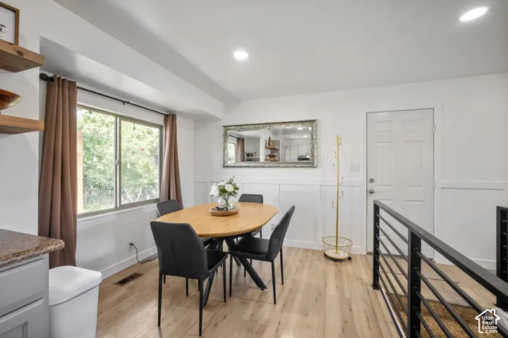 Wood-finish flooring, recessed lighting, and wainscoting details