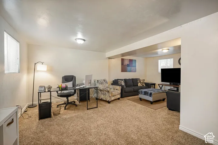 Carpeted living area with recessed lighting, an interior window, and a white ceiling