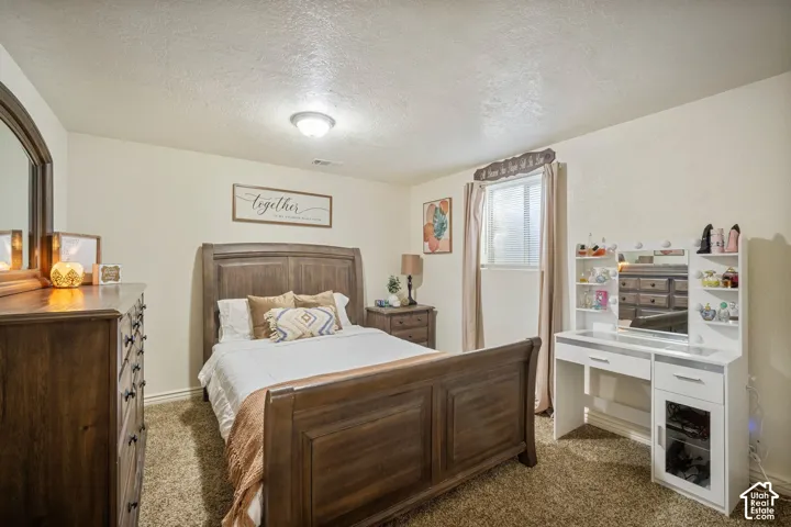 Wall-to-wall carpeting and a single window with blinds