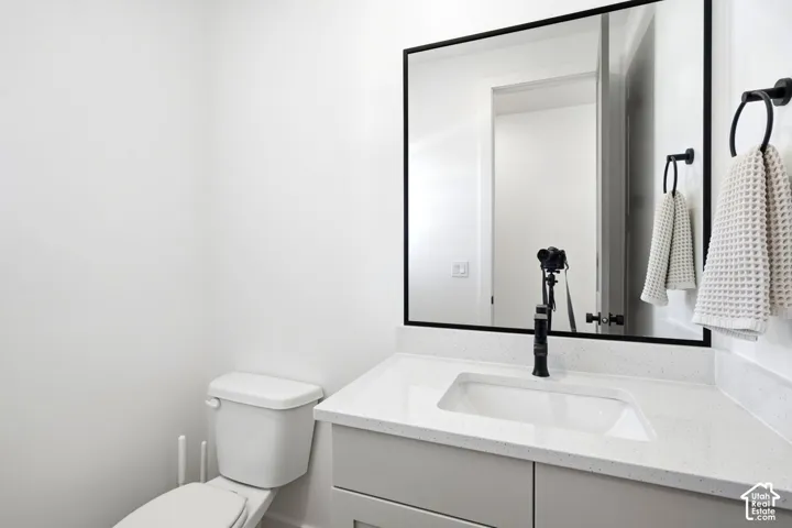 Modern vanity with an integrated rectangular sink, speckled countertop, and matte black faucet