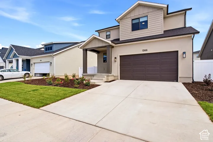 Contemporary stucco and siding exterior with a dark brown panel garage door