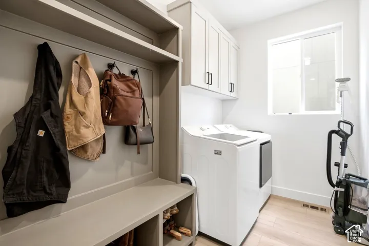 Built-in mudroom bench with storage cubbies and upper shelving