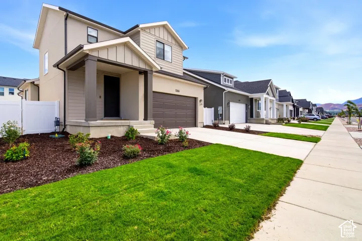 Two-story stucco and siding exterior with an attached garage