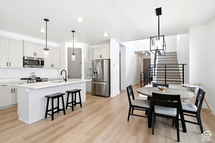 Open-concept kitchen with light wood-finish flooring
