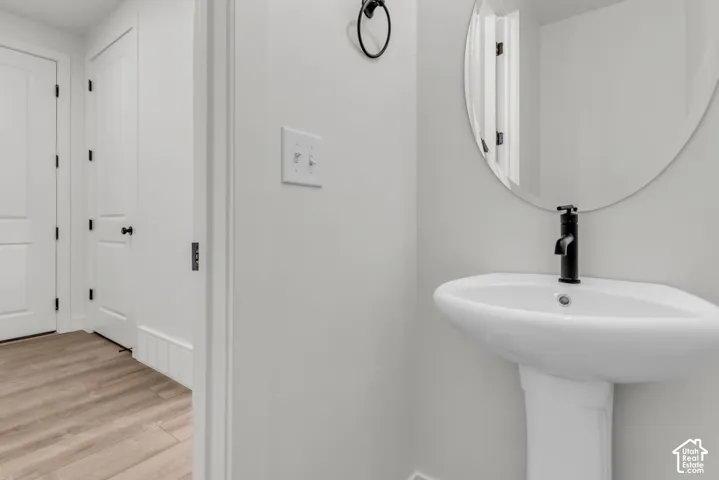 Powder bath with pedestal sink and matte black fixtures.