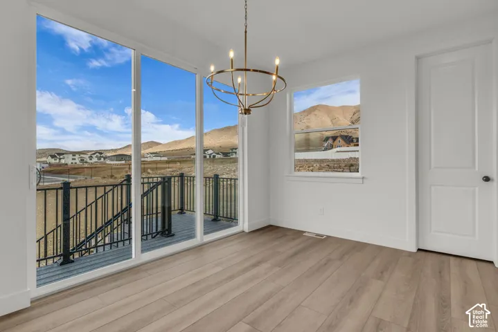 Expansive three panel sliding glass doors, and windows on three sides of this beautiful dining rooms with spectacular mountain views.