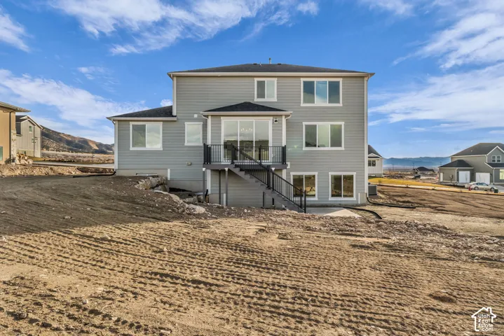 Beautiful view of rear of home, taken from the north property line showing the walkout basement and expansive lot size.