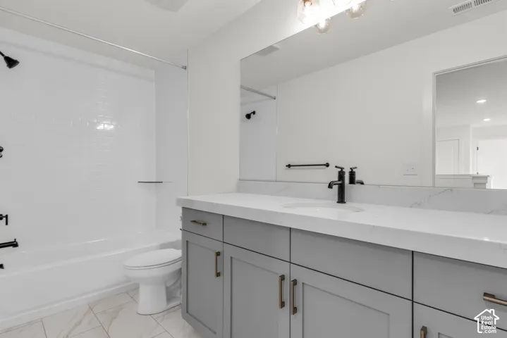 Secondary bath with white subway tile shower surround, matte black fixtures with dove grey cabinetry.
