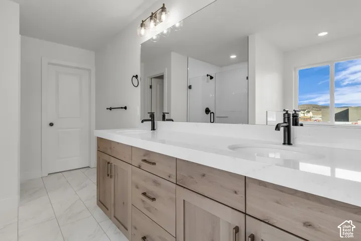 Large primary bath with dual vanity, beautiful stained cabinetry, matte black fixtures.