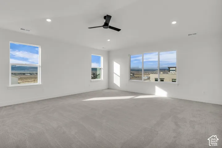 Huge primary bedroom suite, with vaulted ceiling and ceiling fan, and large windows with beautiful views.