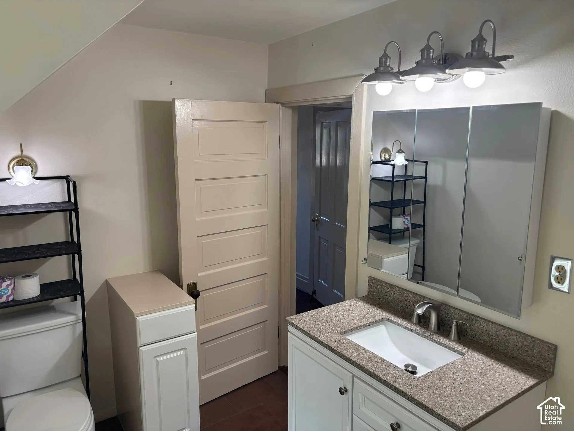 Vanity with integrated sink, speckled countertop, and brushed nickel faucet