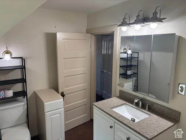 Vanity with integrated sink, speckled countertop, and brushed nickel faucet