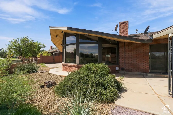 Brick exterior with an angled roofline, large picture windows, and a chimney