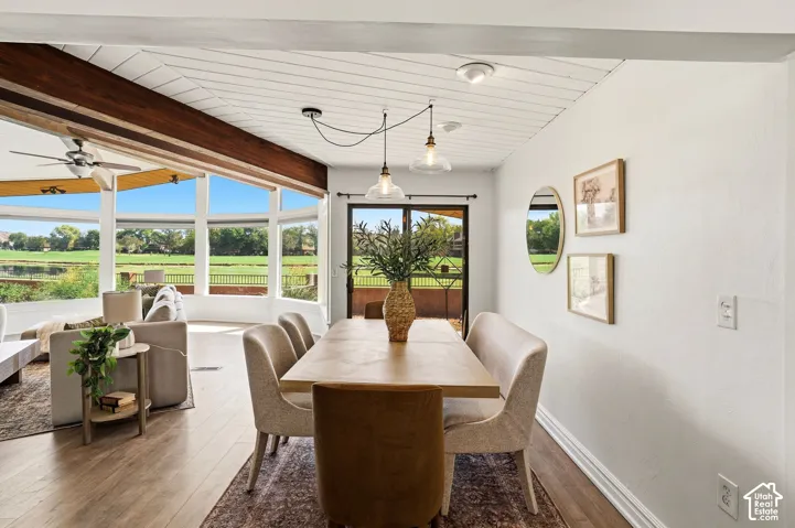Wood-finish flooring, white shiplap ceiling, and pendant lighting