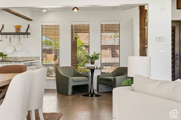 Hardwood-finish flooring, recessed lighting, and exposed wood beam accents