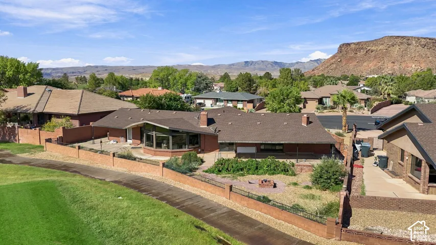 Single-story residence with a brick exterior, a bay window, and a spacious rear patio