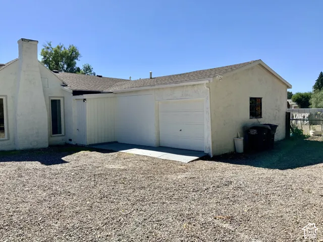 Attached single-car garage with a white overhead door