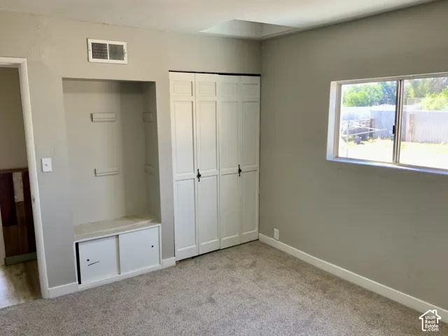 Neutral-toned wall paint with carpet flooring