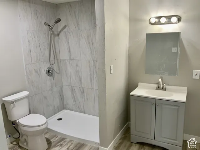 Walk-in shower with tiled surround and handheld showerhead