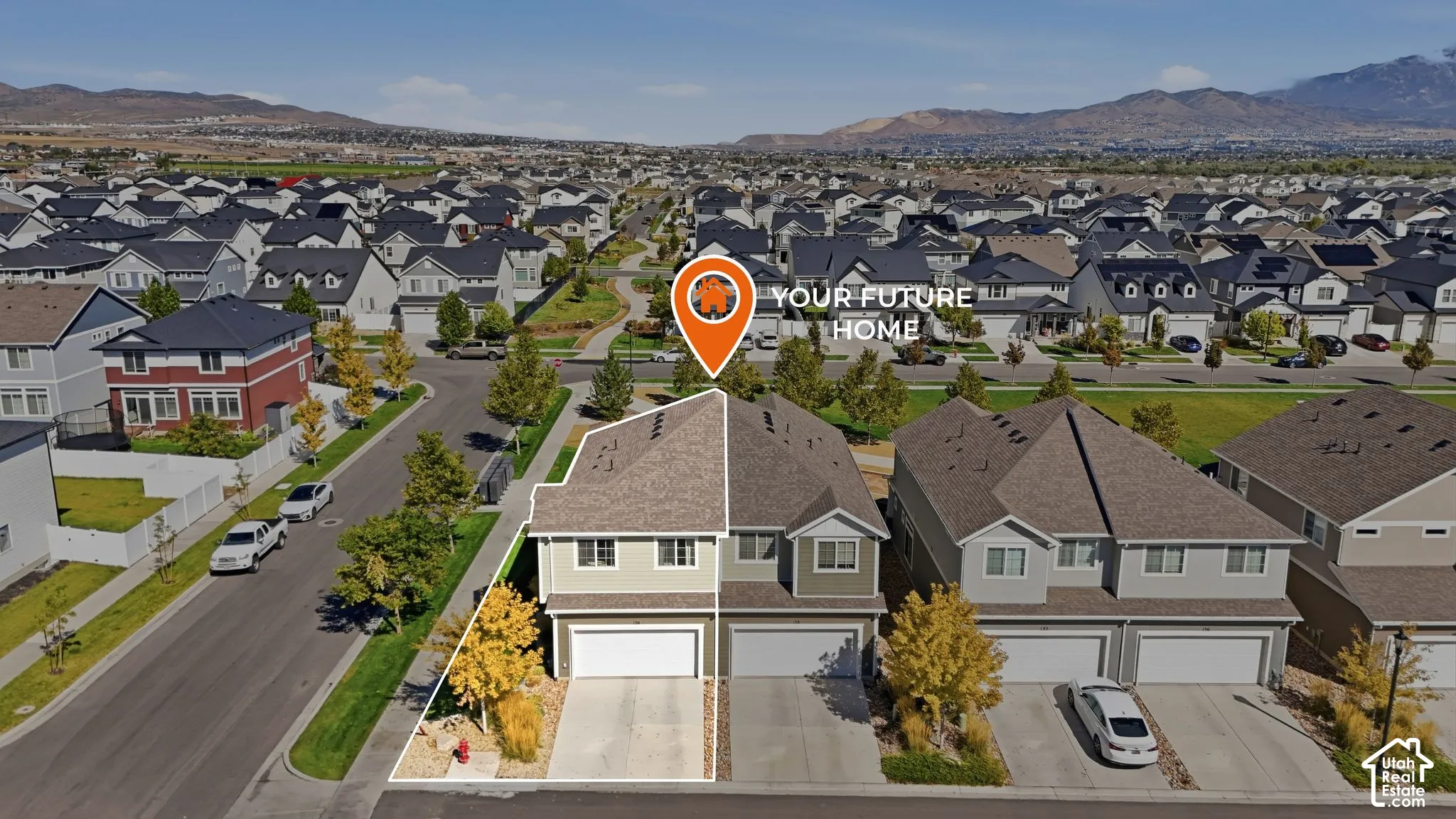 Two-story residence with a two-car garage, established landscaping, and a paved driveway