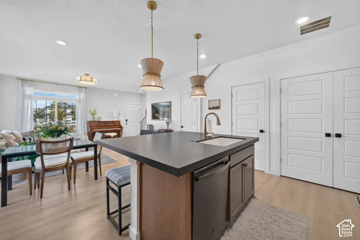 Central kitchen island with an integrated sink and dark countertop
