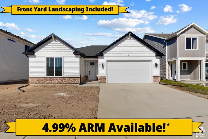 Single-story exterior featuring white horizontal lap and shake siding, masonry stone base, dual-gable roofline, and an attached two-car garage with a concrete driveway