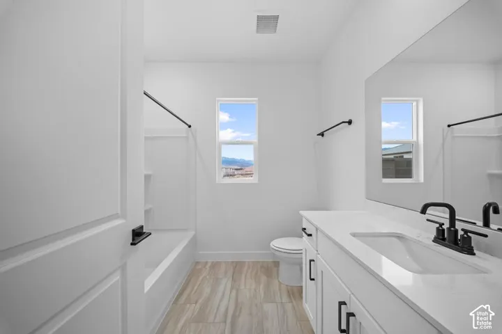 White cabinetry with matte black hardware, integrated sink, and white countertop