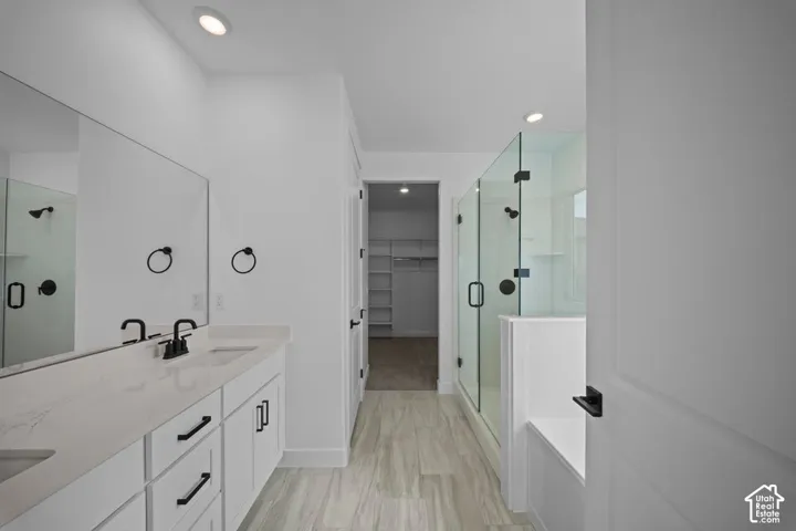 Dual vanity with white cabinetry, integrated sinks, and matte black fixtures