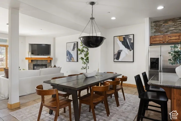 Dining area featuring a dark wood-finish table and pendant lighting