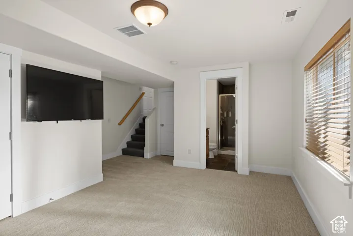 Recessed lighting, wood-finish window blinds, and carpeted flooring