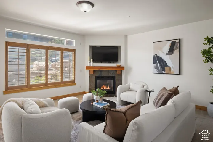 Corner fireplace with stone surround, wood mantel, and integrated media niche