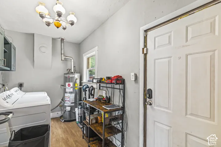 Wood-finish flooring, built-in wall cabinets, and a side-by-side washer and dryer