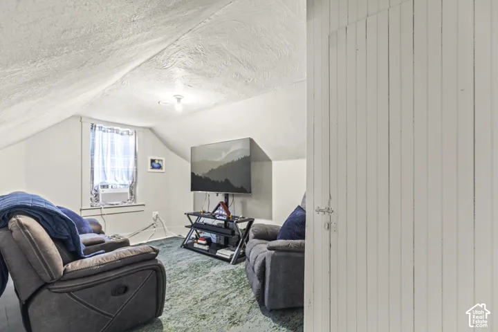 Sloped ceiling detail with recessed window, overhead lighting, and painted panel door