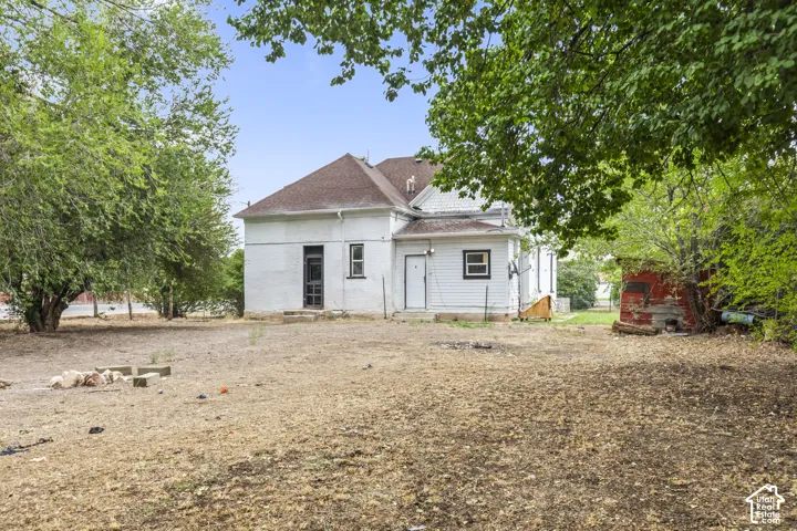 Expansive property with mature trees and a detached structure
