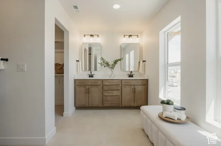 Dual vanity with wood-finish cabinetry and white countertops