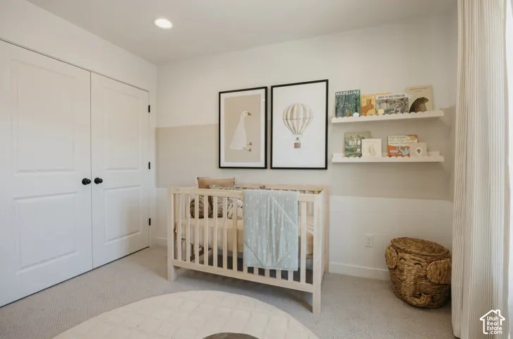 Plush carpet flooring, recessed ceiling lighting, two-tone wall paint, and built-in wall shelving