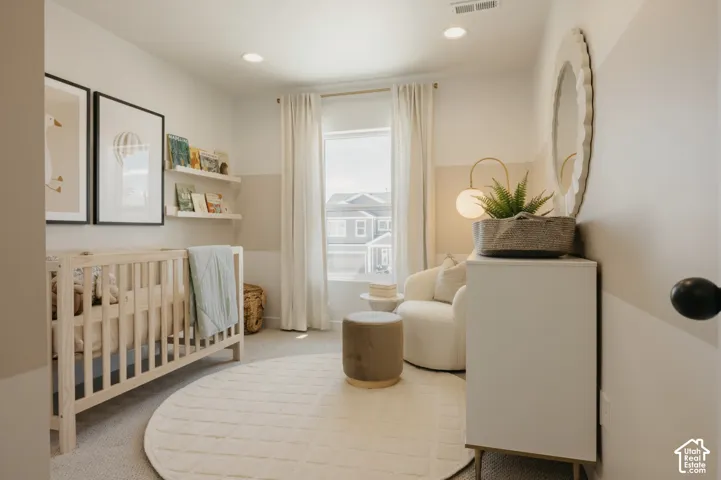 Recessed ceiling lighting, window with light-filtering curtains, two built-in wall shelves, and wall-mounted mirror