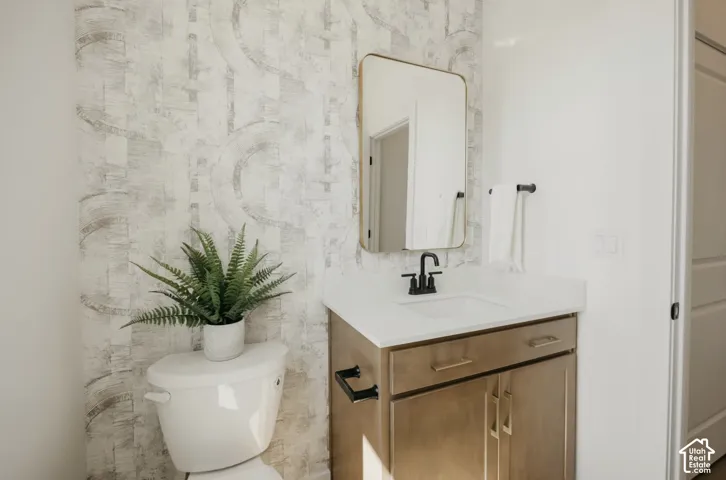 Vanity with a rectangular sink, matte black faucet, and brass hardware