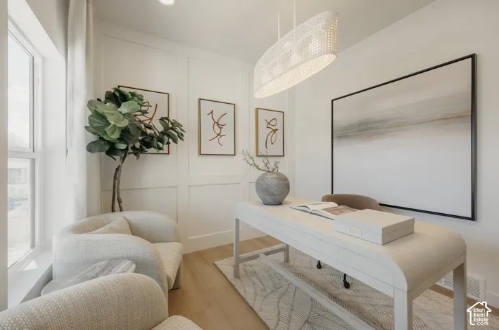 Recessed lighting, wood-finish flooring, and a window with sheer drapes