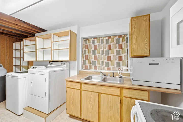 Utility room featuring wood-finish cabinetry, a dual-basin sink, and built-in shelving