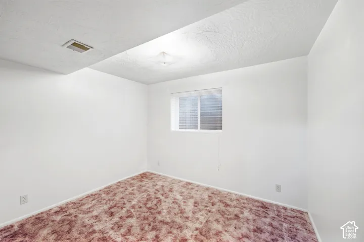 White painted walls and a textured ceiling