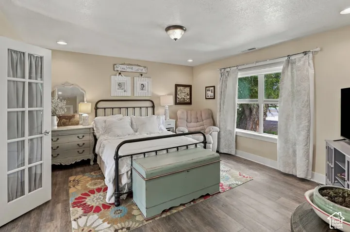 Wood-finish flooring, recessed lighting, and a window with exterior visibility