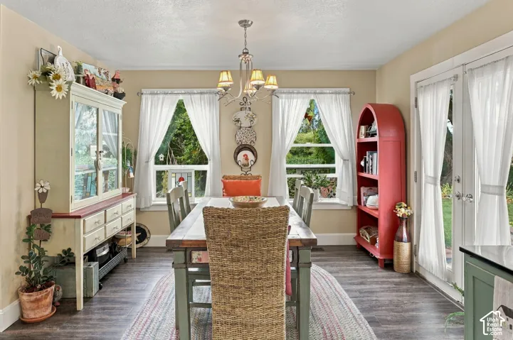 Wood-finish flooring with a multi-light chandelier and recessed lighting
