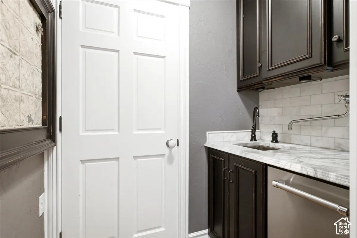 Custom cabinetry with a light-toned countertop and subway tile backsplash