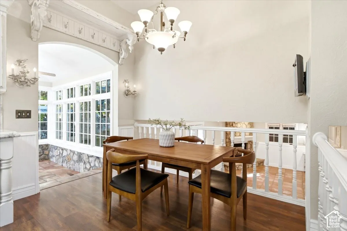 Wood-finish flooring with an arched entry featuring decorative millwork and corbels