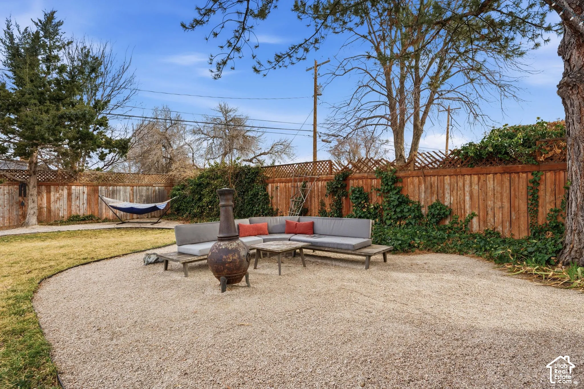 Expansive backyard with a gravel patio and a manicured lawn area