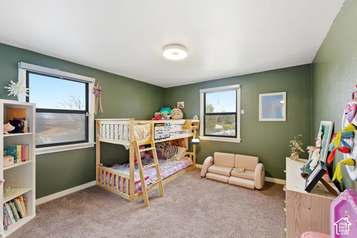 Carpeted room featuring two windows, recessed lighting, and painted walls