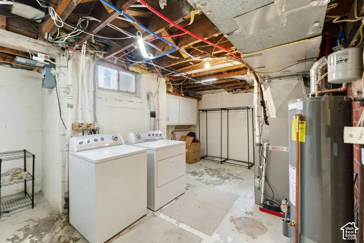 Laundry area with washer and dryer, utility sink, exposed ceiling beams, and a water heater