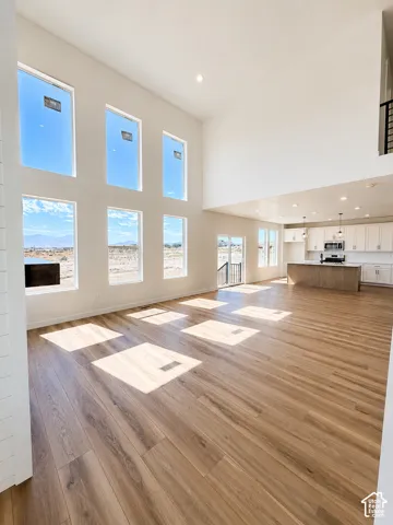 Soaring ceilings, abundant natural light, wood-finish flooring, recessed lighting, and an open-concept layout
