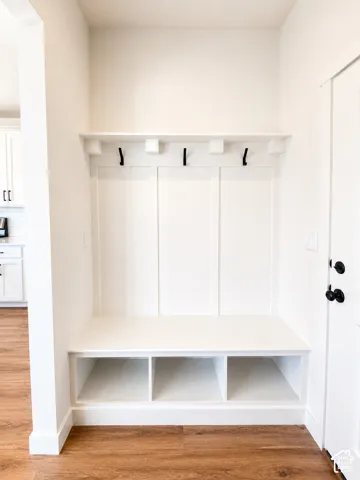 Built-in hall tree featuring board and batten paneling, integrated bench seating, and open cubby storage